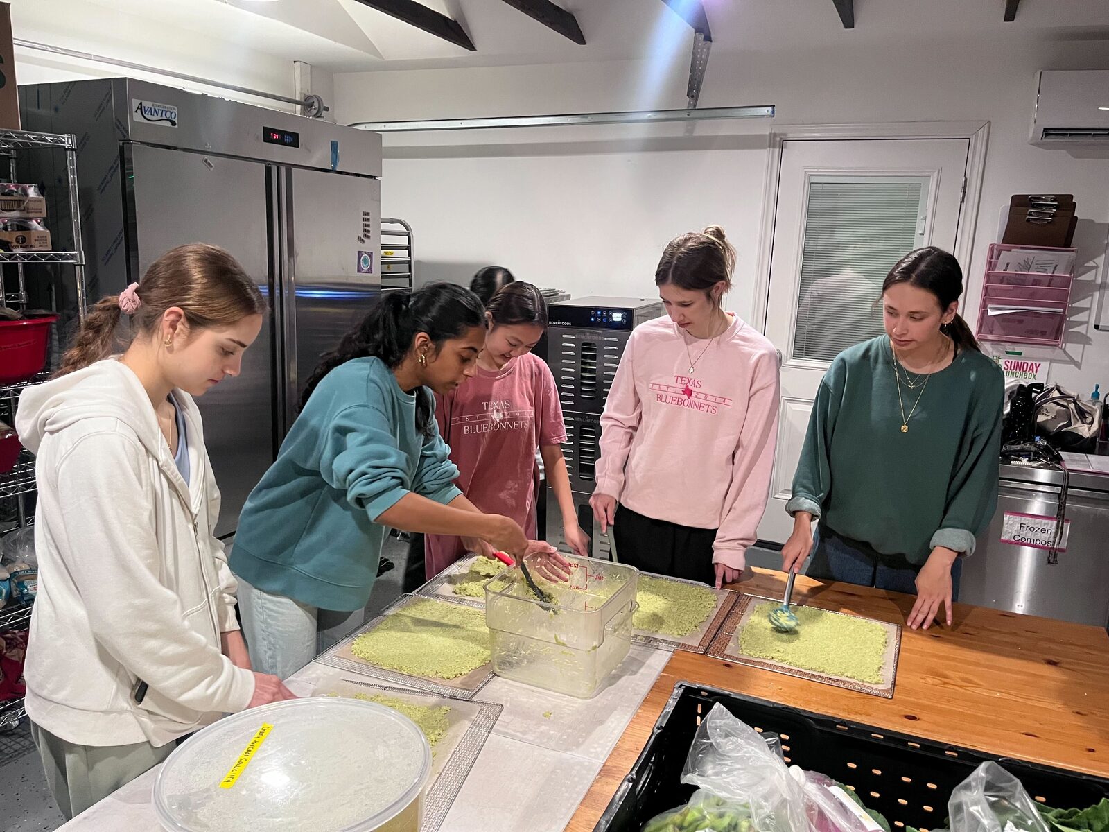 Volunteers preparing whole food at the Lunchbox kitchen